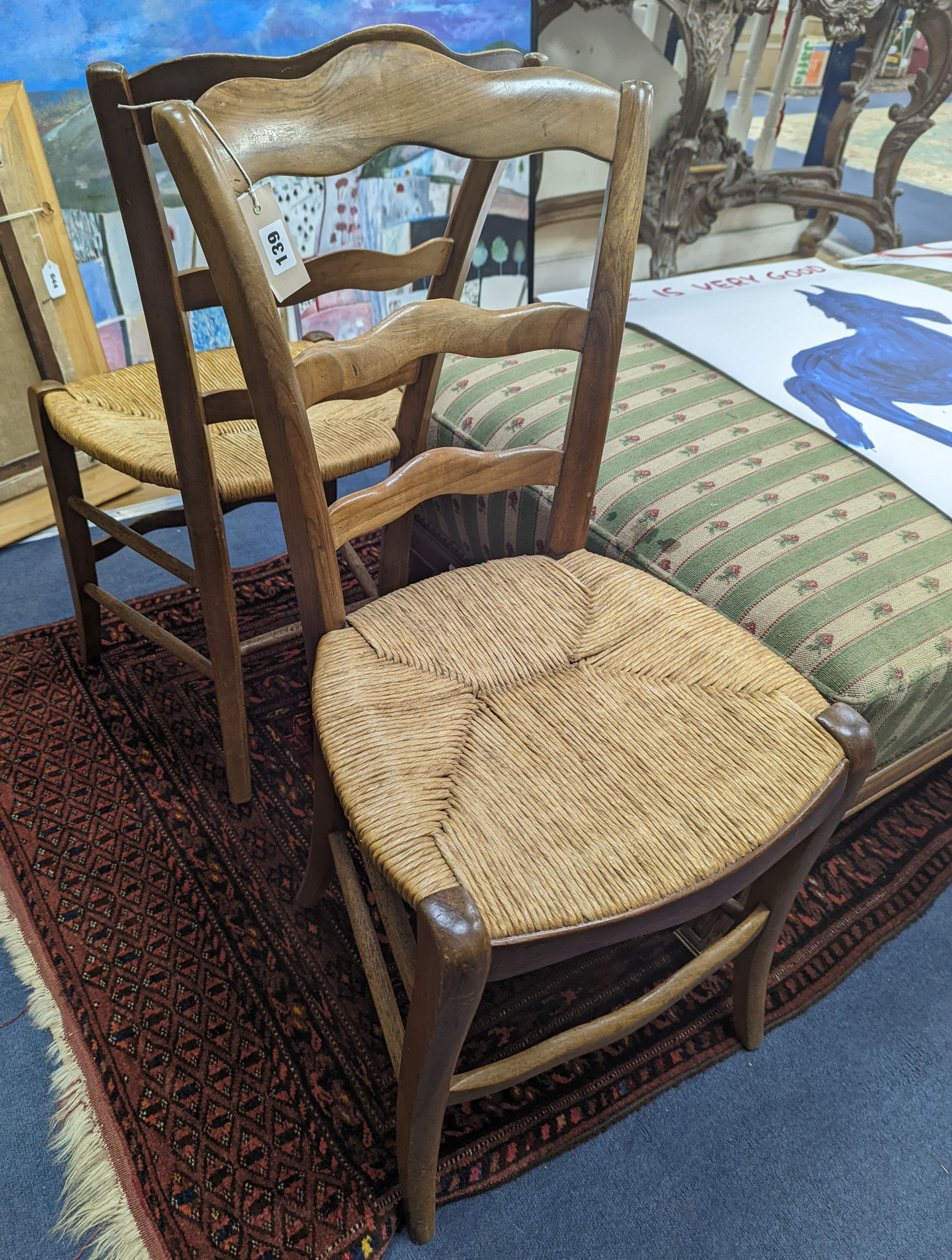 A pair of 19th century French rush seat walnut dining chairs